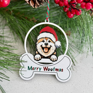 Christmas ornament with a dog wearing a Santa hat and 'Merry Woofmas' text, surrounded by greenery and berries.