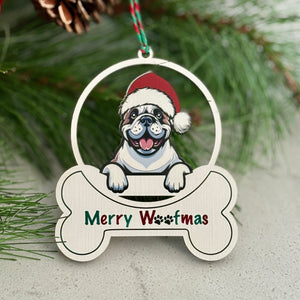 Christmas ornament with a dog wearing a Santa hat and 'Merry Woofmas' text, surrounded by greenery and berries.