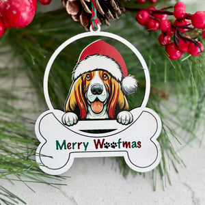 Christmas ornament with a dog wearing a Santa hat and 'Merry Woofmas' text, surrounded by greenery and berries.