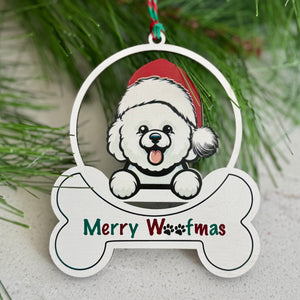 Christmas ornament with a dog wearing a Santa hat and 'Merry Woofmas' text, hanging on a branch.