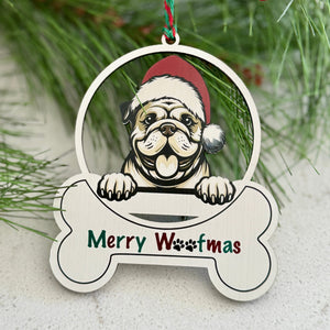 Christmas ornament with a dog wearing a Santa hat and 'Merry Woofmas' text, hanging on a tree branch with berries.