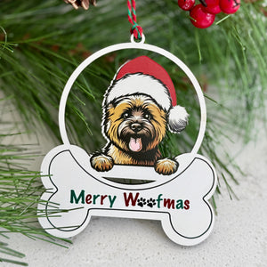 Christmas ornament with a dog wearing a Santa hat and 'Merry Woofmas' text, surrounded by pine branches and berries.