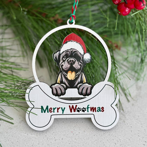 Christmas ornament with a dog wearing a Santa hat and 'Merry Woofmas' text, hanging on a tree.
