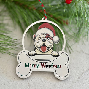 Christmas ornament with a dog wearing a Santa hat and 'Merry Woofmas' text, hanging on a branch.