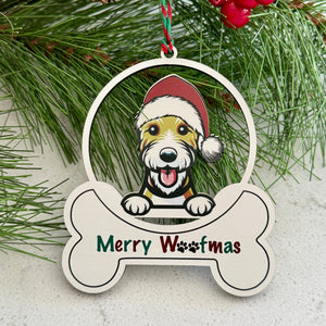 Christmas ornament with a dog wearing a Santa hat and 'Merry Woofmas' text, surrounded by pine branches and berries.