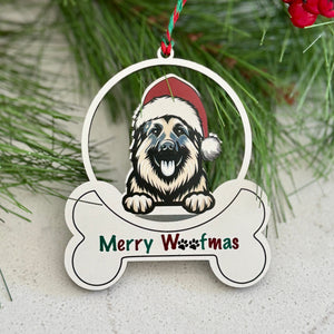 Christmas ornament with a dog wearing a Santa hat and 'Merry Woofmas' text, surrounded by greenery and berries.