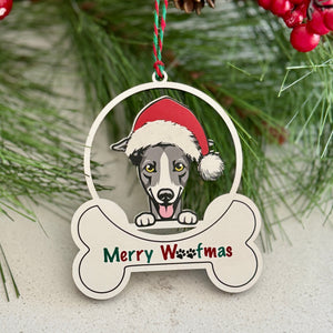 Christmas ornament with a dog wearing a Santa hat and 'Merry Westmas' text, surrounded by pine branches and red berries.
