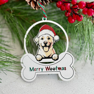 Christmas ornament with a dog wearing a Santa hat and 'Merry Woofmas' text, surrounded by pine branches and berries.