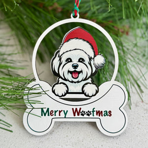 Christmas ornament with a dog wearing a Santa hat and 'Merry Woofmas' text, surrounded by pine branches and berries.
