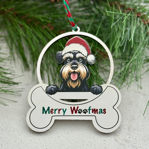 Christmas ornament with a dog wearing a Santa hat and 'Merry Woofmas' text, surrounded by pine branches and berries.