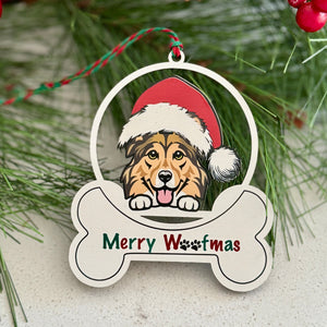 Christmas ornament with a dog wearing a Santa hat and 'Merry Woofmas' text, surrounded by pine branches and red berries.