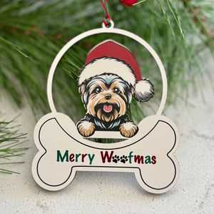 Christmas ornament with a dog design and 'Merry Woofmas' text, surrounded by greenery and berries.