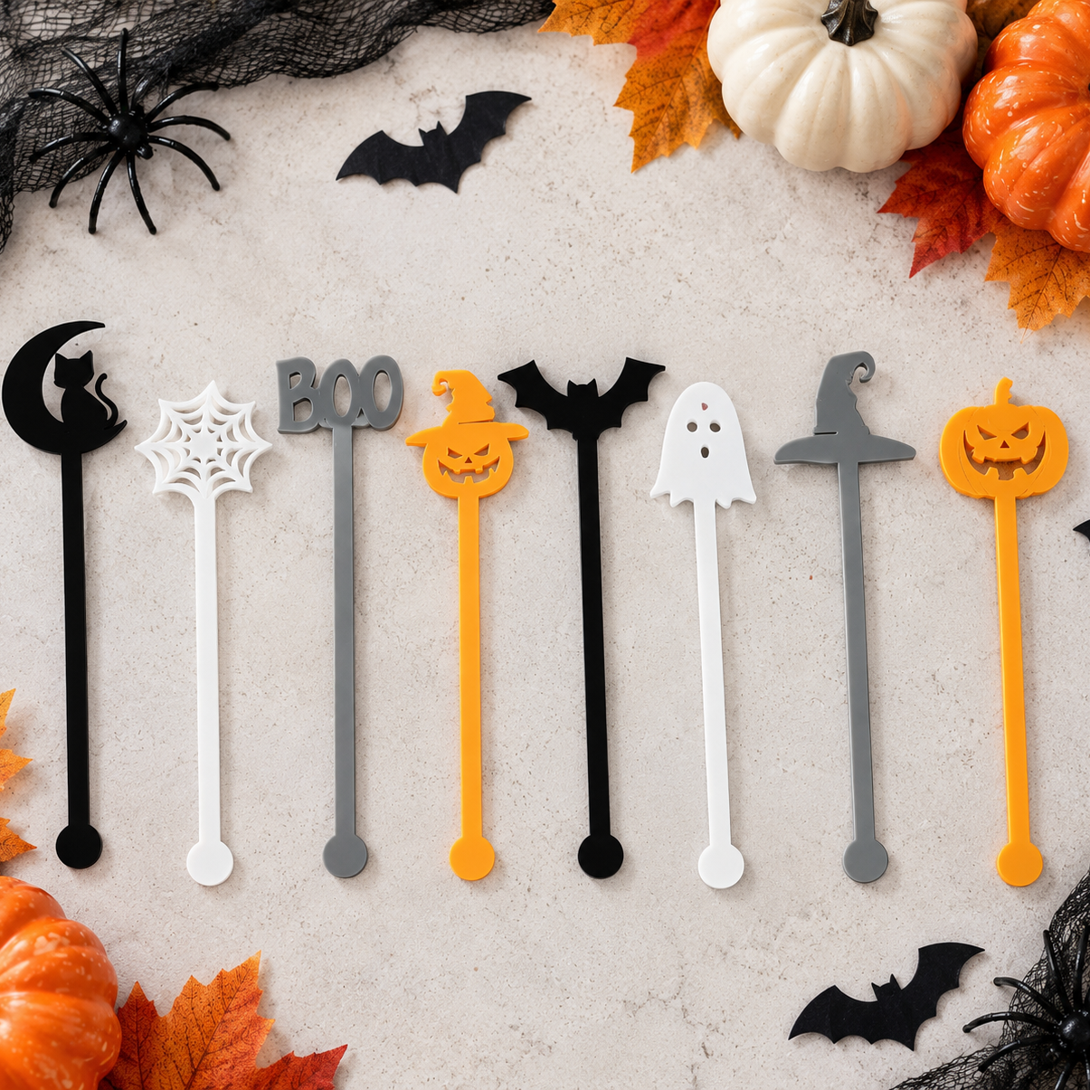 Halloween acrylic cocktail stirrers in black, white, grey and orange featuring ghost, bat, pumpkin, witch hat, spiderweb, BOO and black cat designs