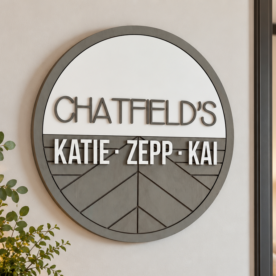 Personalized round wooden nursery name sign featuring names n raised 3D lettering, neutral wood tones and engraved geometric chevron pattern.
