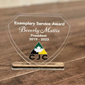 Exemplary Service Award for Beverly Mattis on a wooden surface