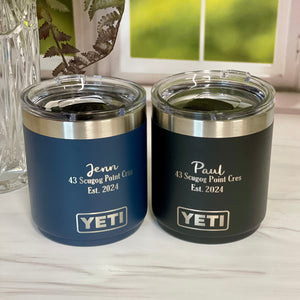 Two YETI tumblers on a white surface with a blurred background