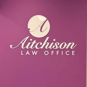A purple office wall with a white 'Aitchison LAW OFFICE' logo and an open doorway showing an interior room.