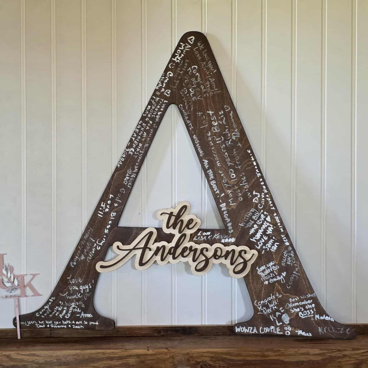 Decorative wooden sign with 'the Andersons' on a rustic background
