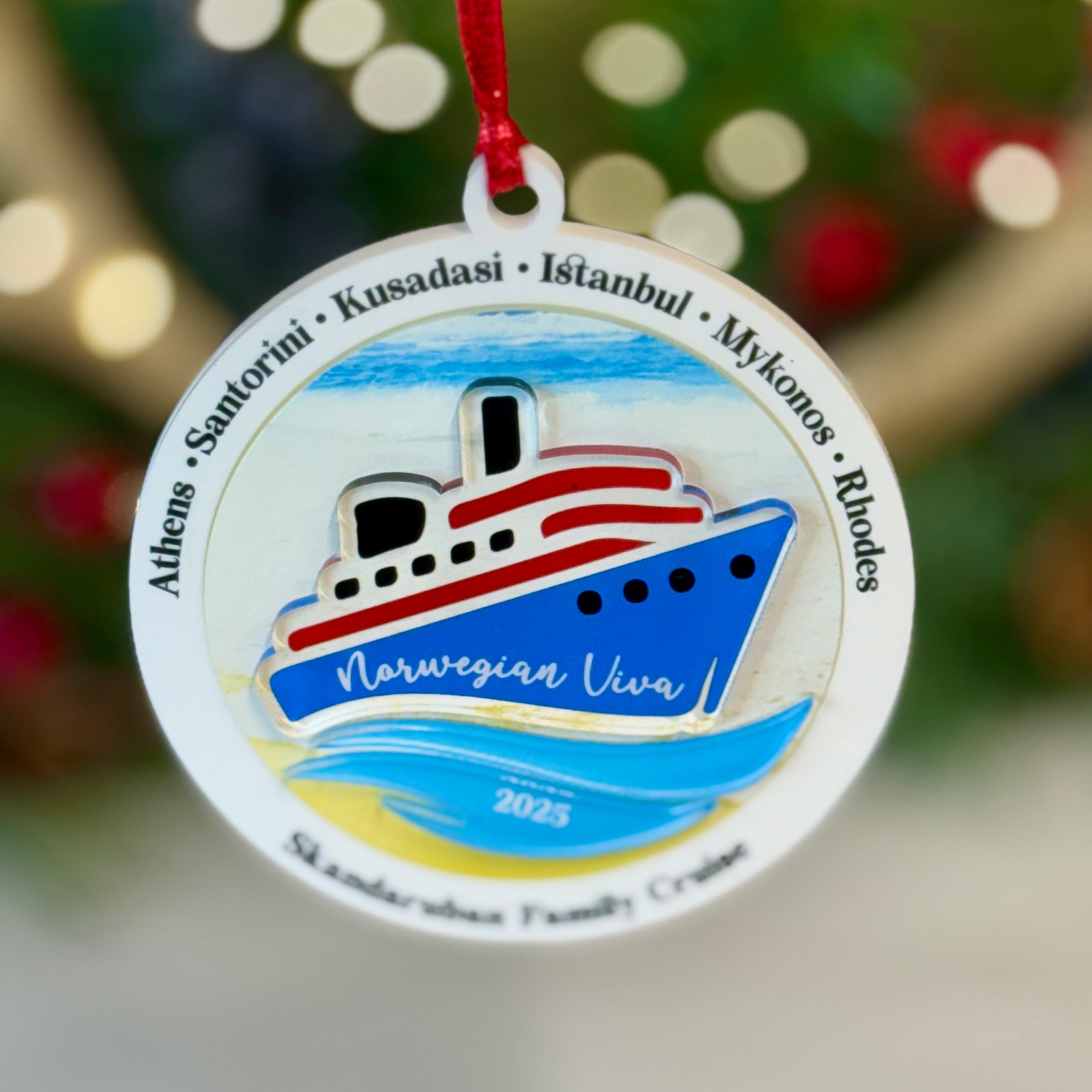 Decorative Christmas ornament with a ship design and text on a blurred festive background