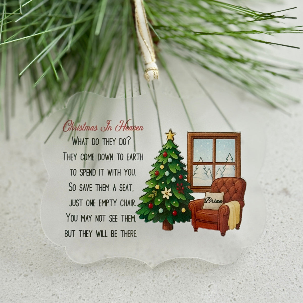Decorative Christmas ornament with a chair, tree, and text on a white background.
