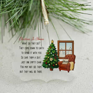 Decorative Christmas ornament with a chair, tree, and text on a white background.