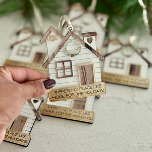 Decorative house ornament with a quote on a neutral background