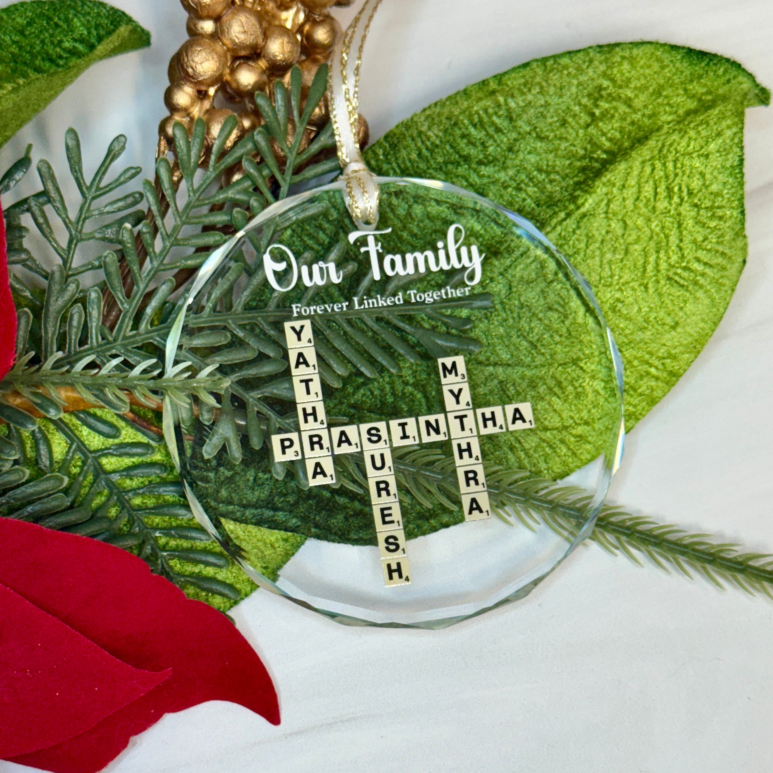 Decorative glass ornament with Christmas-themed design on a white background