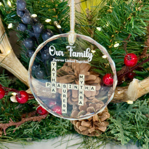 Decorative Christmas ornament with antlers, pinecones, and berries on a green wreath.